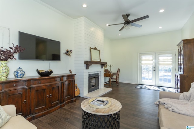 living room featuring recessed lighting, french doors, dark wood finished floors, and a fireplace