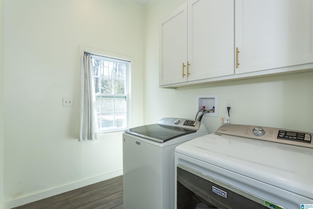 laundry area with baseboards, cabinet space, dark wood-type flooring, and washing machine and dryer