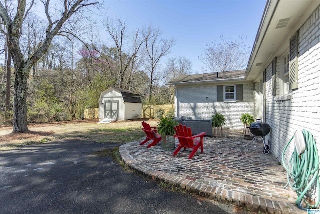 view of yard with a storage shed, an outdoor structure, and a patio area