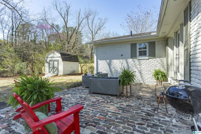 view of patio with a storage unit, an outbuilding, and area for grilling