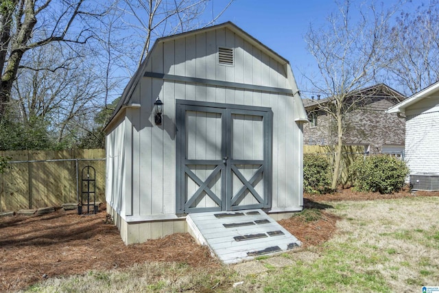 view of shed with central AC unit and fence