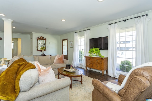 living area with recessed lighting, decorative columns, wood finished floors, and ornamental molding