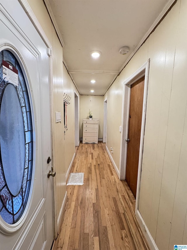 hall with baseboards and light wood-type flooring