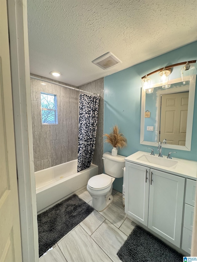 bathroom with vanity, visible vents, shower / tub combo, a textured ceiling, and toilet