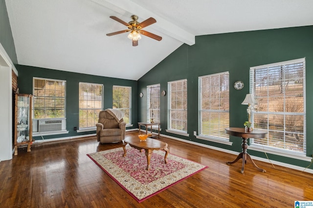 sitting room with beamed ceiling, wood finished floors, baseboards, and ceiling fan