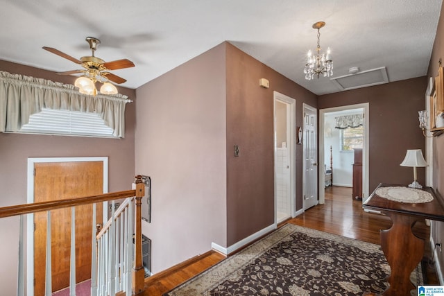 foyer entrance featuring wood finished floors, baseboards, and ceiling fan