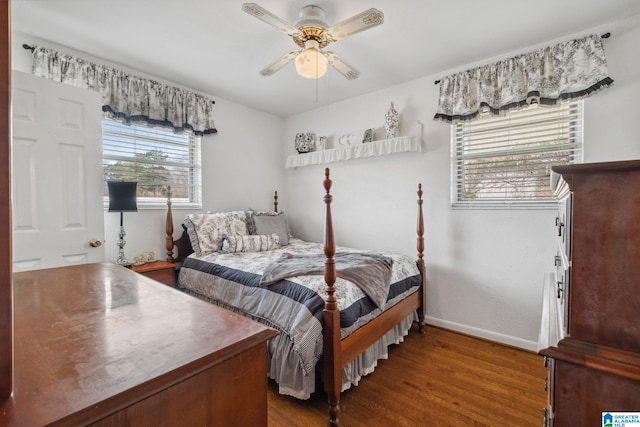 bedroom featuring baseboards, wood finished floors, and a ceiling fan