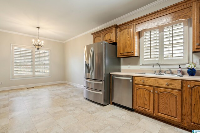 kitchen with light countertops, brown cabinets, appliances with stainless steel finishes, and ornamental molding