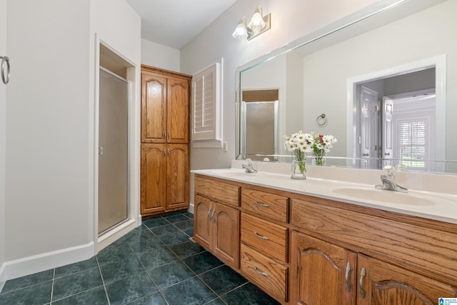 full bath with a sink, a shower stall, and tile patterned flooring