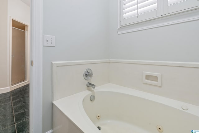 full bath with a shower stall and a jetted tub