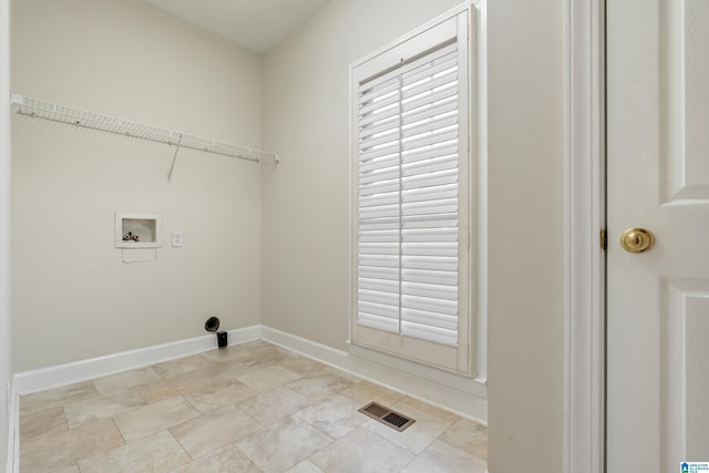 laundry area with laundry area, baseboards, visible vents, and washer hookup