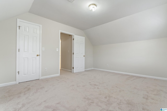 bonus room with vaulted ceiling, carpet, and baseboards