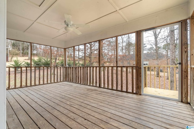 unfurnished sunroom with a ceiling fan