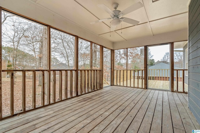 unfurnished sunroom featuring ceiling fan