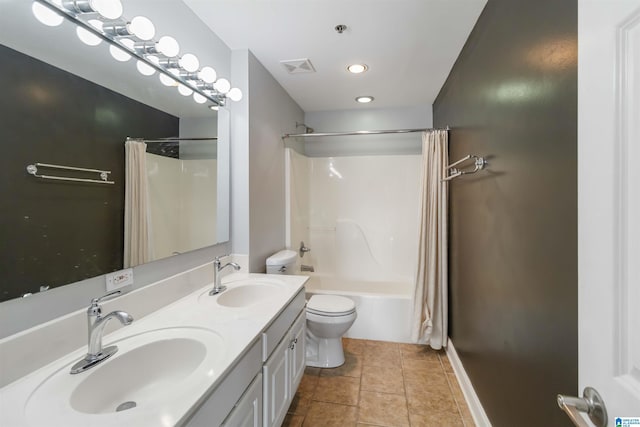 bathroom featuring a sink, visible vents, toilet, and tile patterned floors