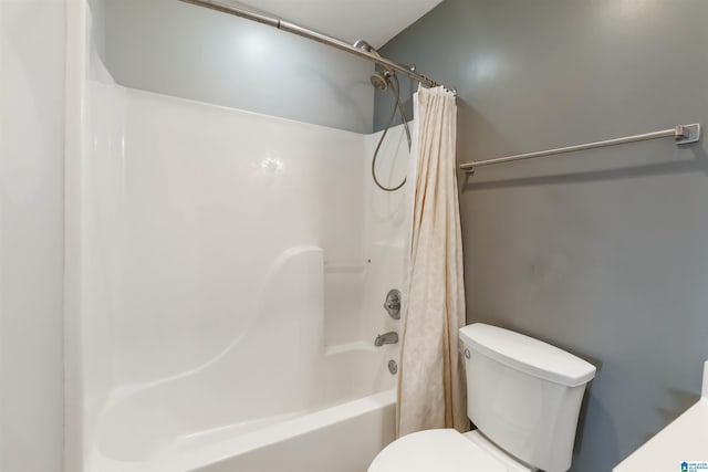 full bathroom featuring toilet and shower / tub combo with curtain