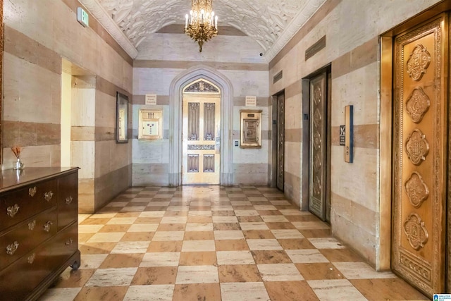 corridor with lofted ceiling, brick ceiling, and a chandelier