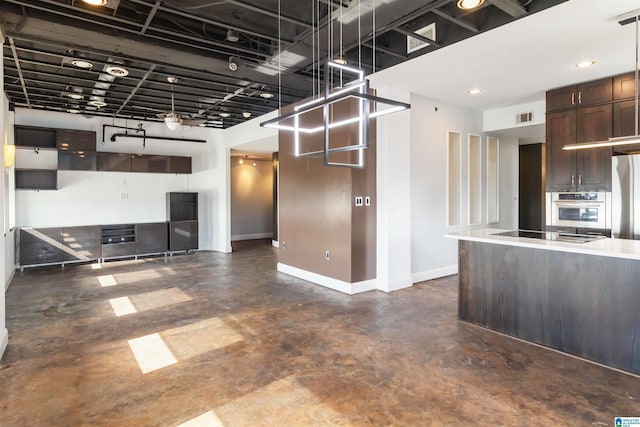 kitchen with visible vents, dark brown cabinetry, stainless steel oven, black electric cooktop, and baseboards