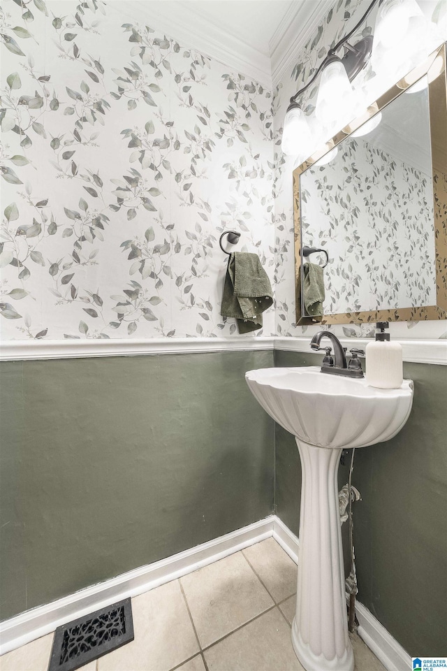 bathroom featuring visible vents, a wainscoted wall, wallpapered walls, crown molding, and tile patterned floors