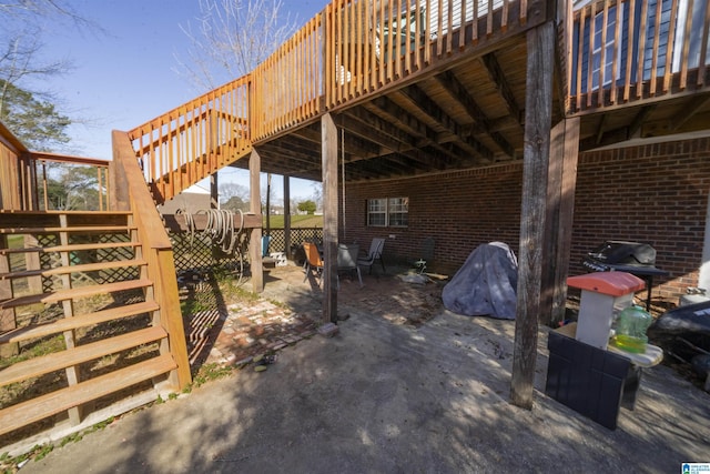 view of patio with stairs and a deck