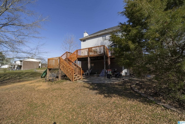 rear view of property with a patio area, stairway, a chimney, and a deck