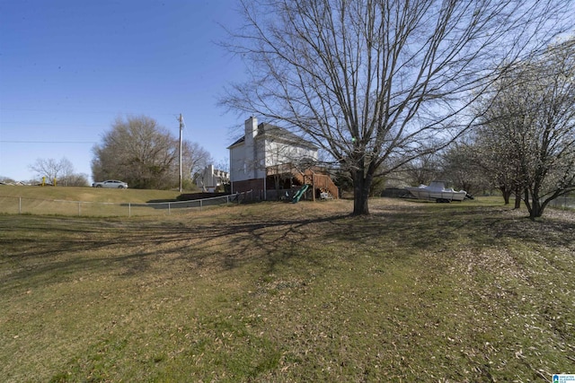 view of yard with a playground and fence