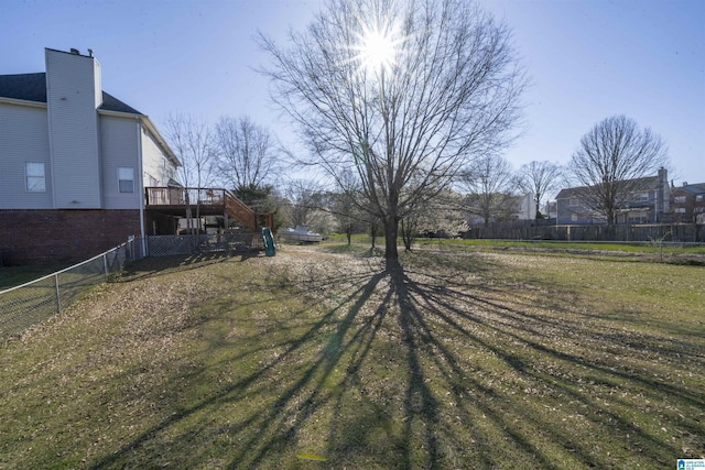 view of yard featuring stairway, a wooden deck, and fence