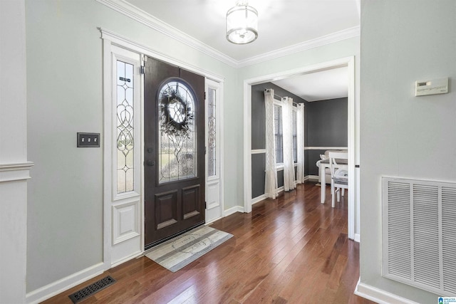 entrance foyer with a wealth of natural light, visible vents, and hardwood / wood-style flooring