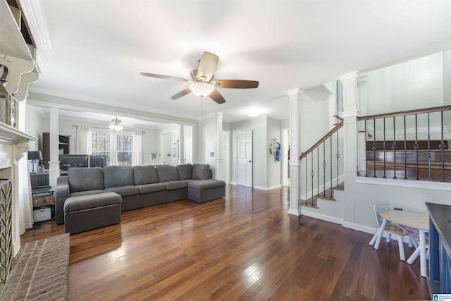 living room with hardwood / wood-style floors, stairway, ornate columns, and ceiling fan