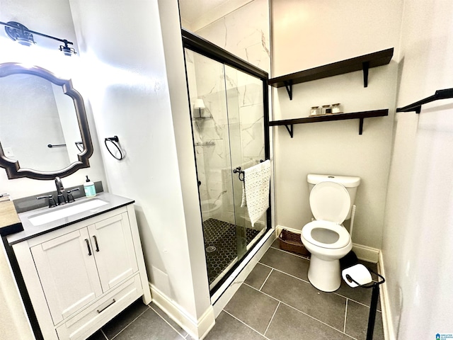 full bathroom featuring vanity, a shower stall, toilet, and baseboards