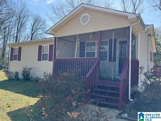 view of front of home featuring a sunroom