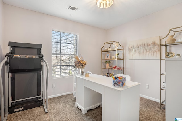 carpeted home office with visible vents and baseboards