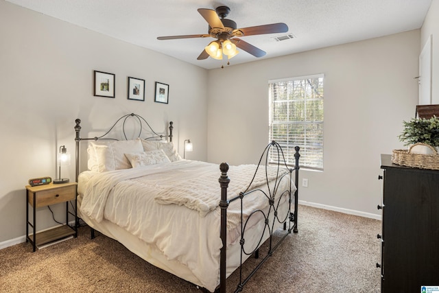 bedroom featuring visible vents, a ceiling fan, baseboards, and carpet floors