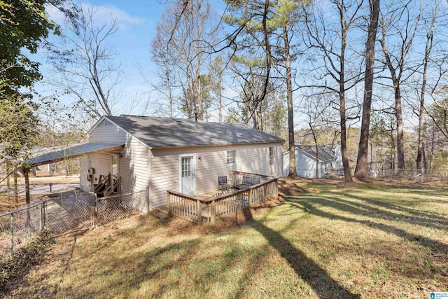 exterior space featuring a wooden deck, a lawn, and a fenced backyard