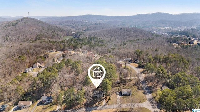 birds eye view of property with a mountain view and a forest view