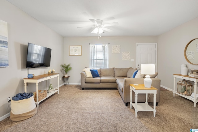 living room with baseboards, ceiling fan, and carpet flooring