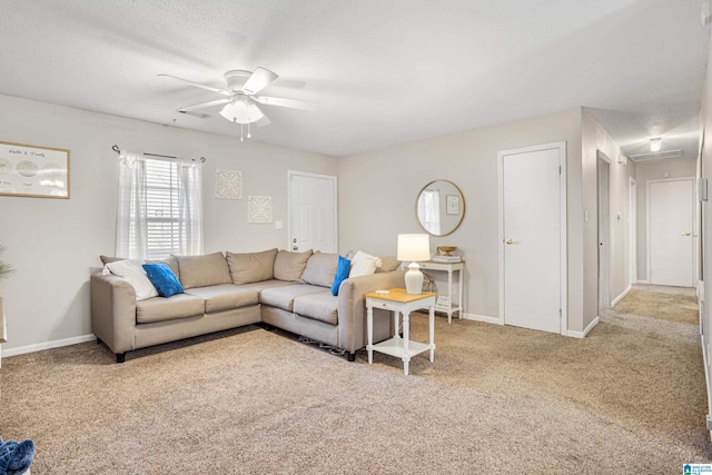 living room featuring a textured ceiling, baseboards, carpet floors, and ceiling fan