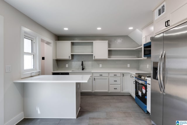 kitchen with tasteful backsplash, open shelves, light countertops, appliances with stainless steel finishes, and a sink