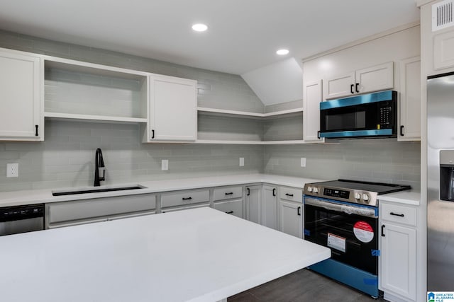 kitchen with open shelves, a sink, backsplash, appliances with stainless steel finishes, and light countertops