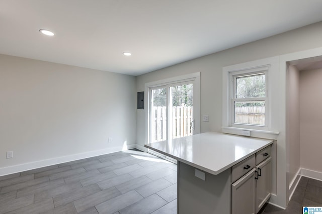 kitchen with recessed lighting, light countertops, and baseboards