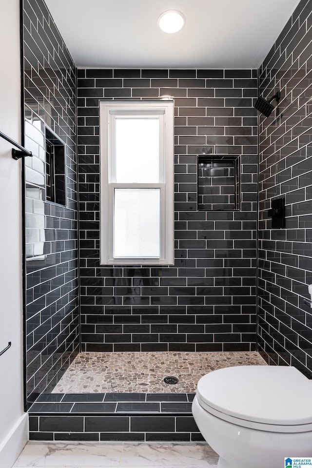 bathroom with toilet and tiled shower