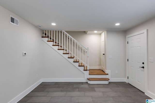 entryway with recessed lighting, visible vents, baseboards, and stairs