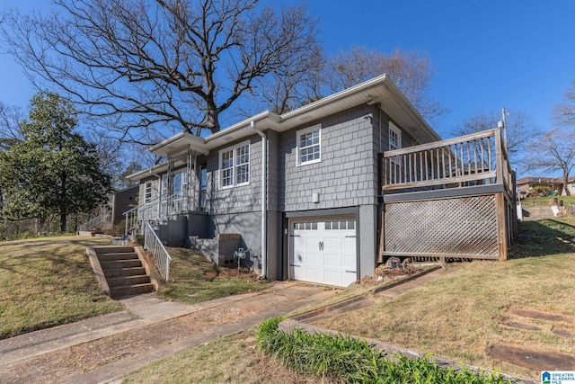 view of home's exterior with stairway, a lawn, driveway, and a garage