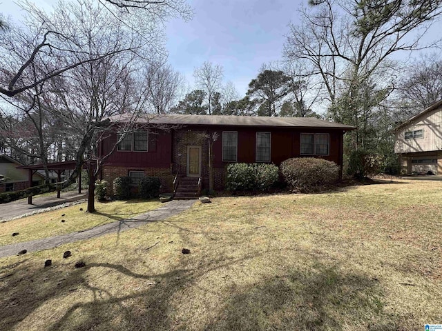 view of front of property with a front yard and brick siding