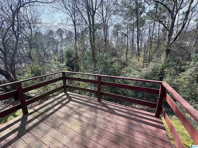 wooden terrace featuring a wooded view