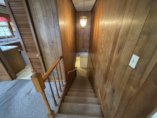 stairs featuring wooden walls