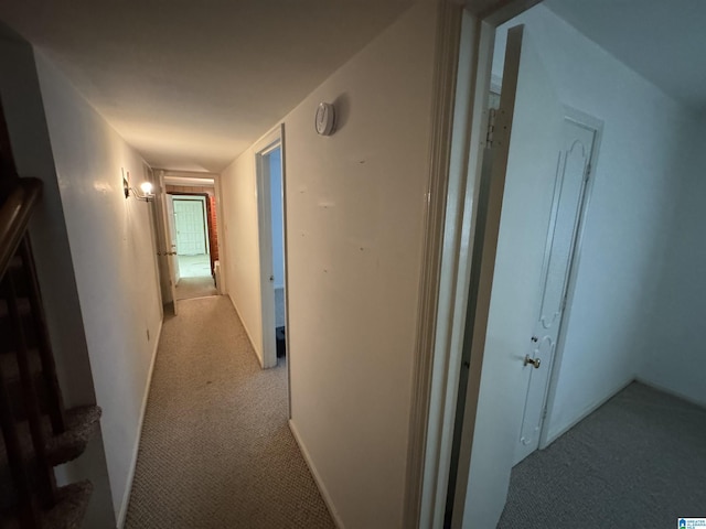 corridor with stairway and carpet