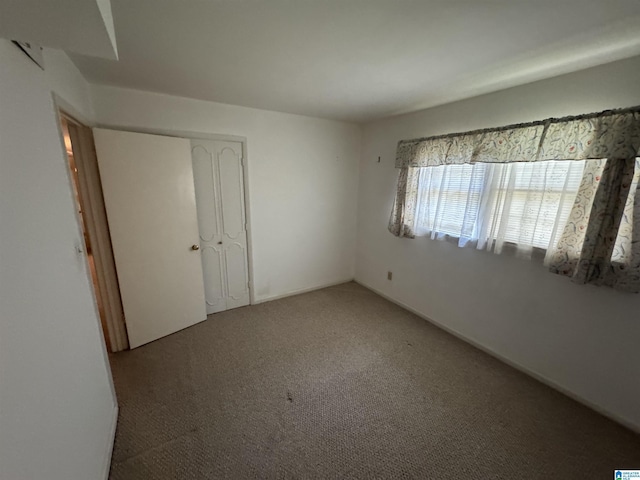 unfurnished bedroom with light carpet and a closet