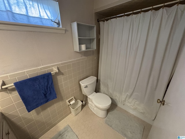 bathroom with toilet, tile walls, and tile patterned flooring