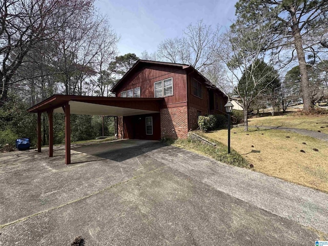 view of side of property with brick siding and driveway